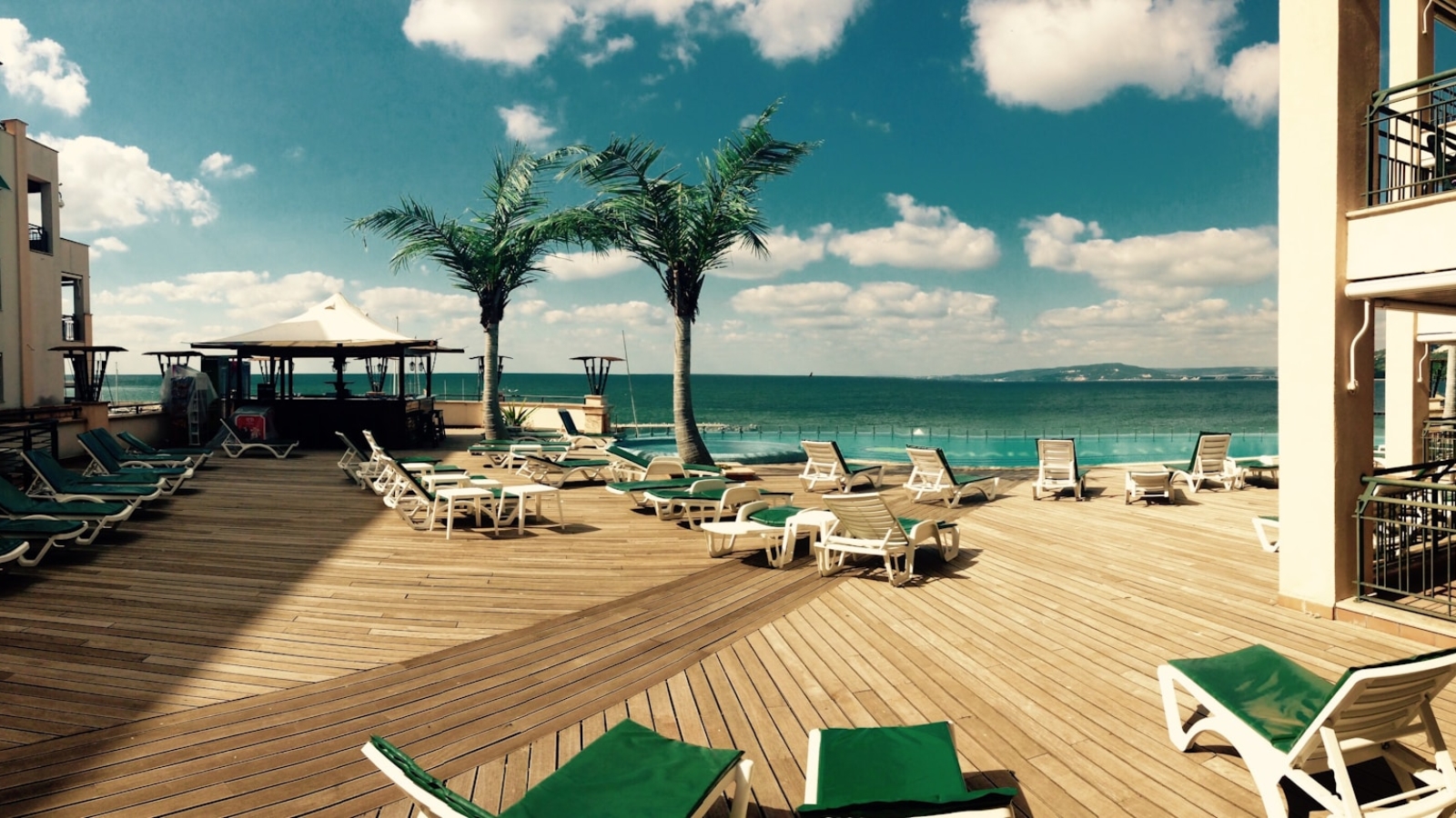 green loungers on dock at daytime