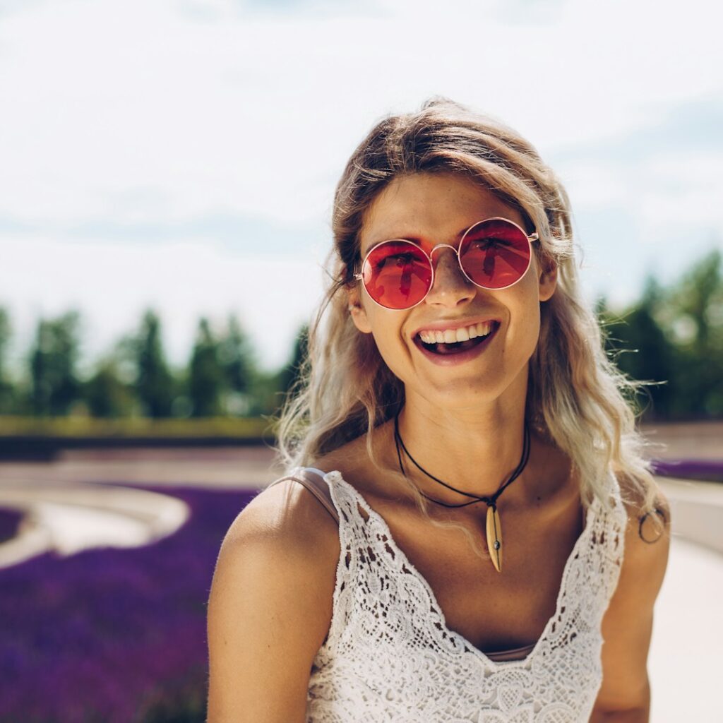 woman in white floral tank top wearing sunglasses