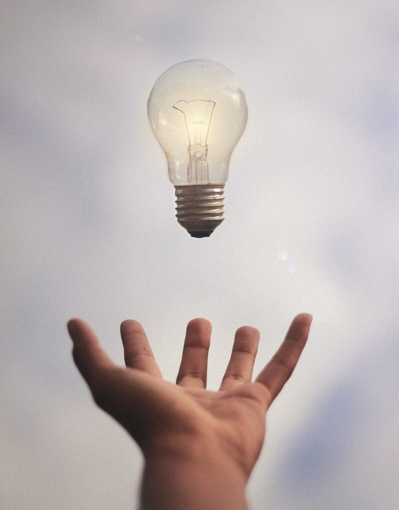 person catching light bulb