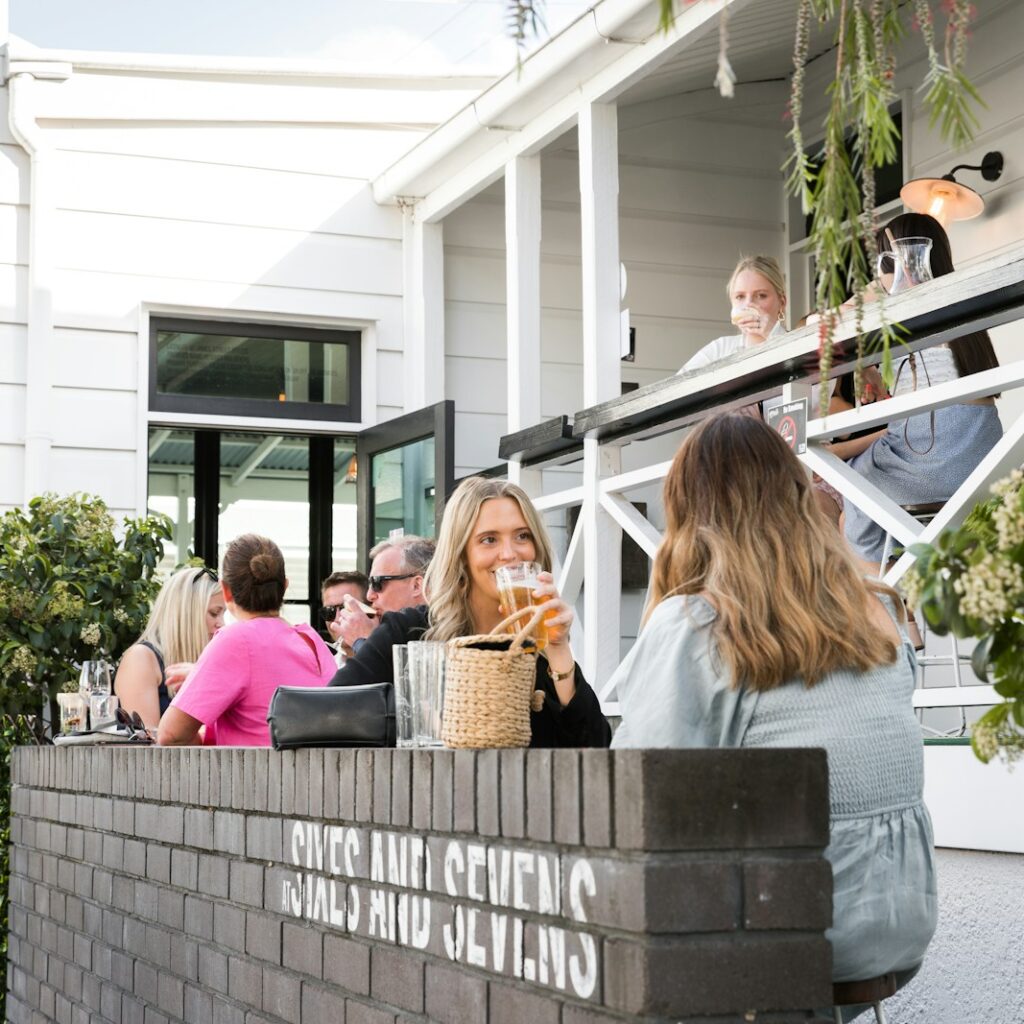 people sitting on gray concrete bench during daytime