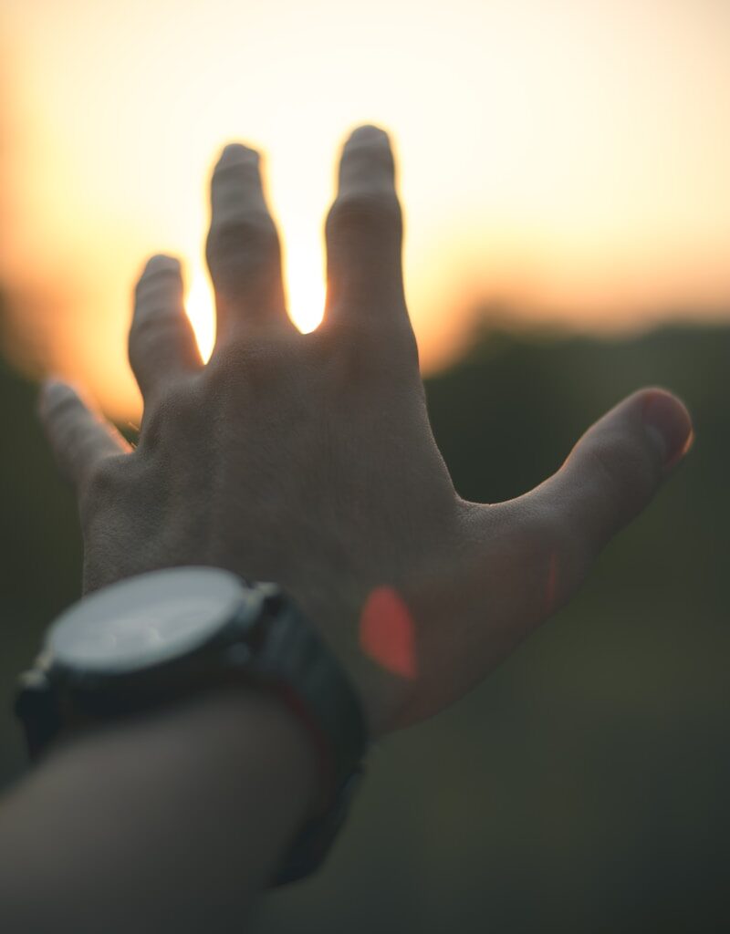 photo of person reaching out his hand