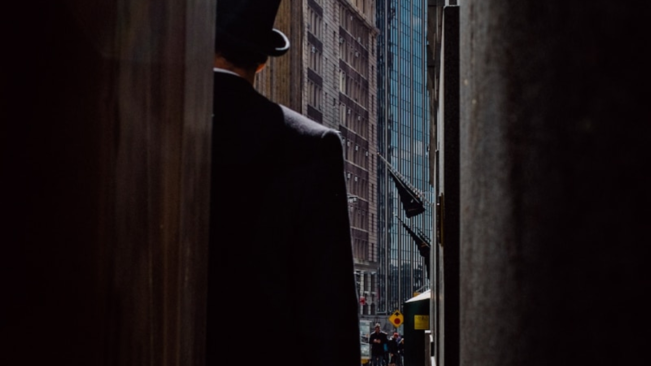 man wearing top hat standing near buildings