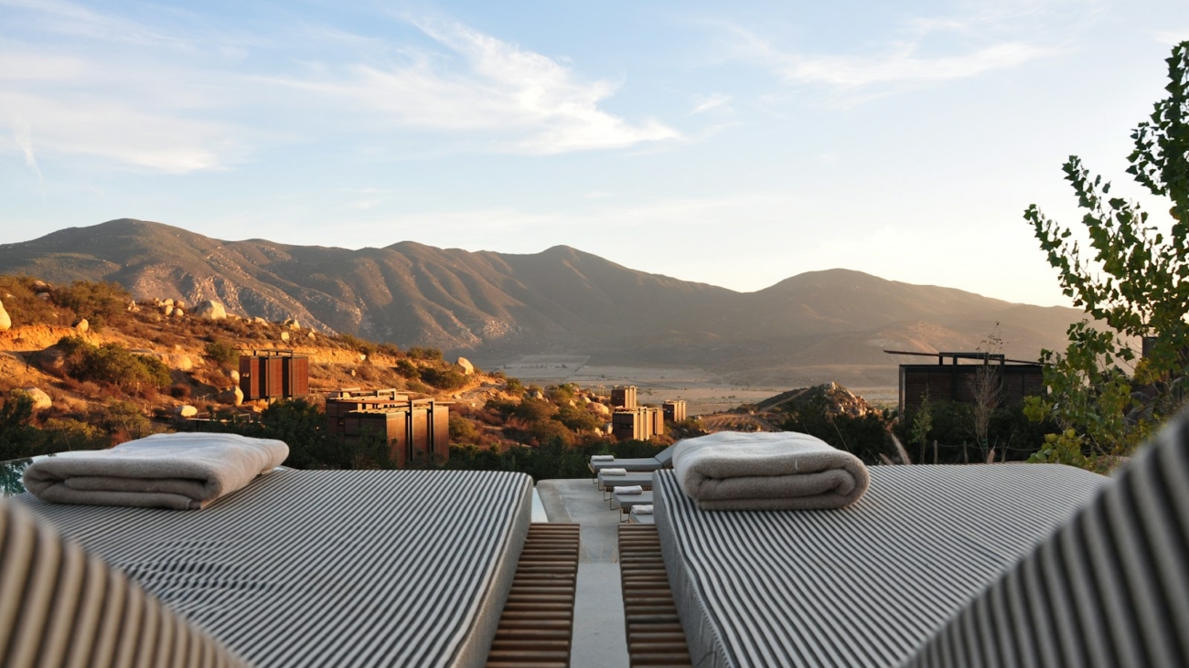 sunloungers fronting buildings near mountain