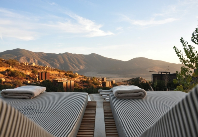 sunloungers fronting buildings near mountain