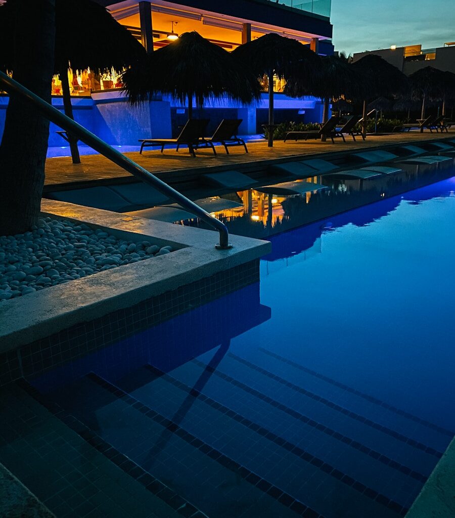 swimming pool near trees during night time