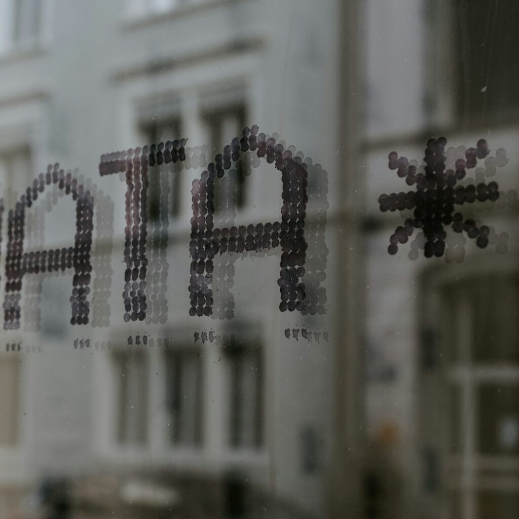 a close up of a window with a building in the background