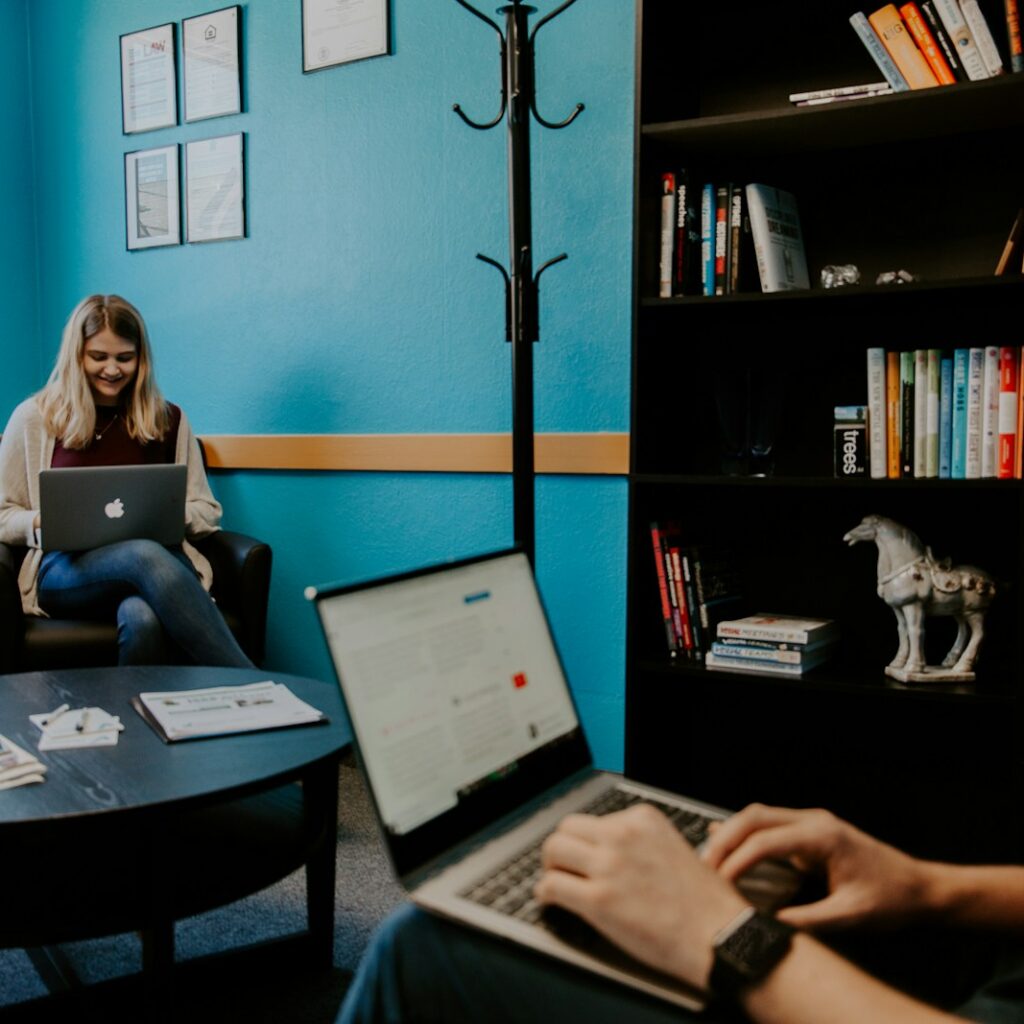 smiling man using black and gray laptop computer