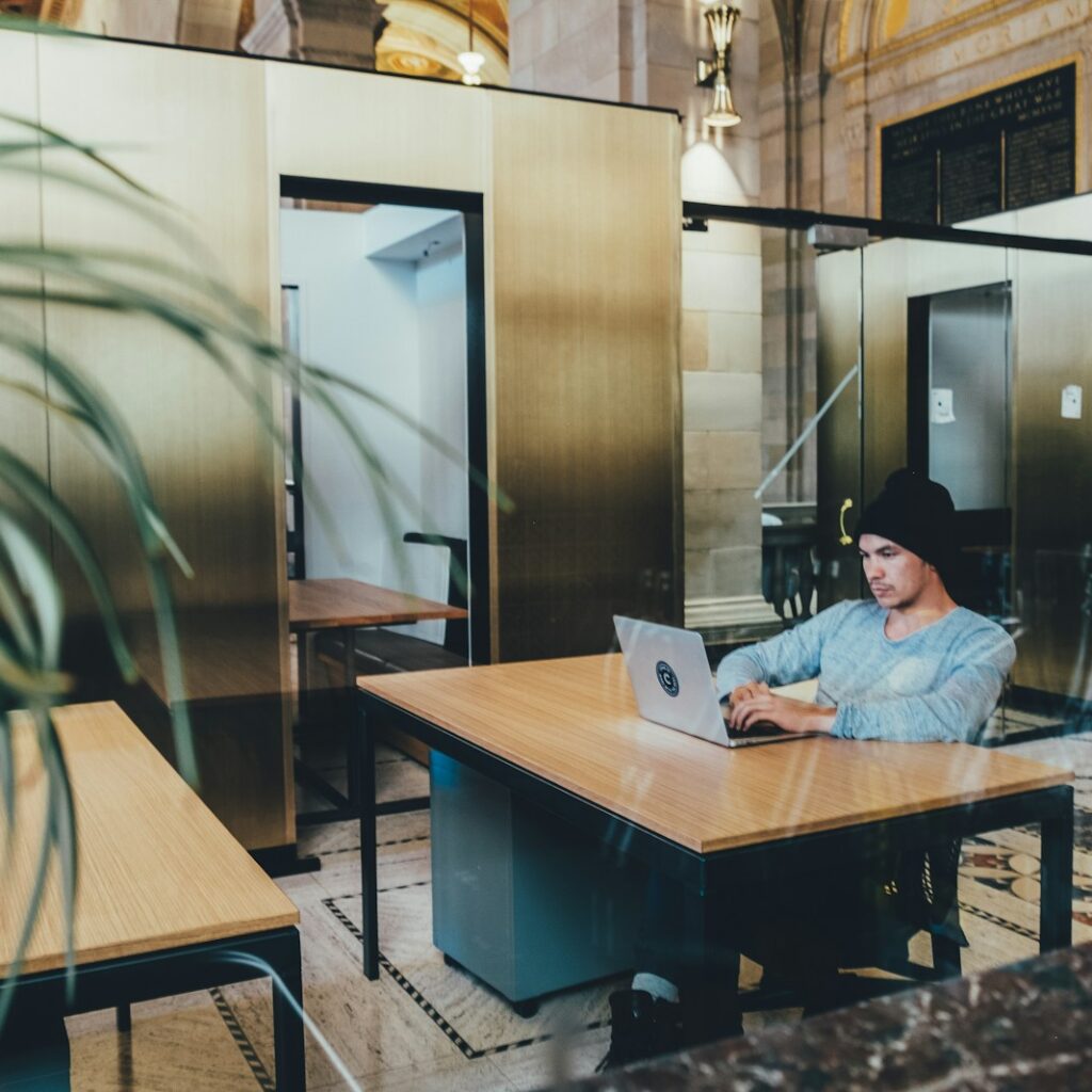 man using a gray laptop computer