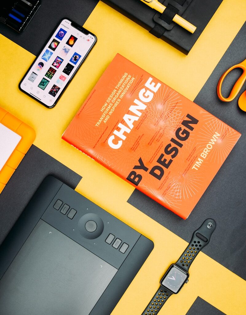 Change by Design by Tim Brown book beside smartphone