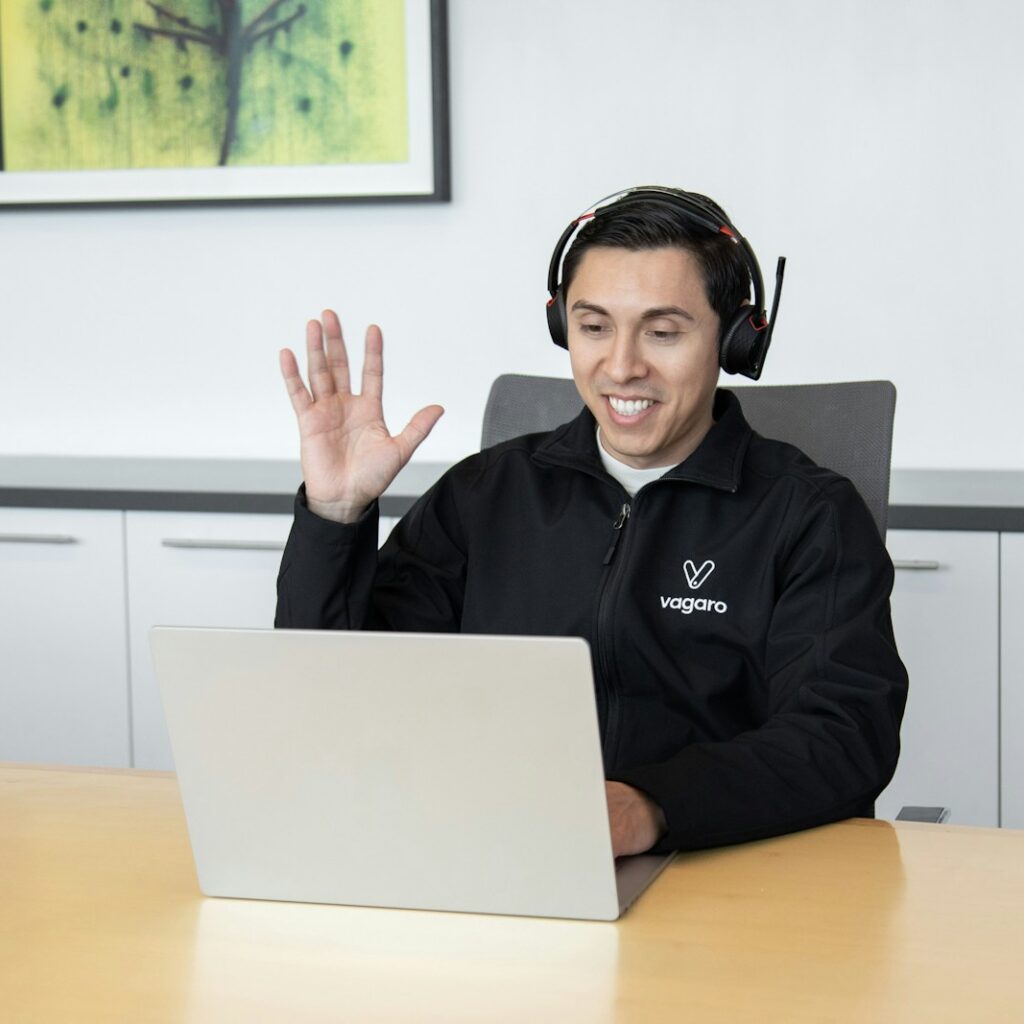 a man wearing headphones sitting in front of a laptop computer