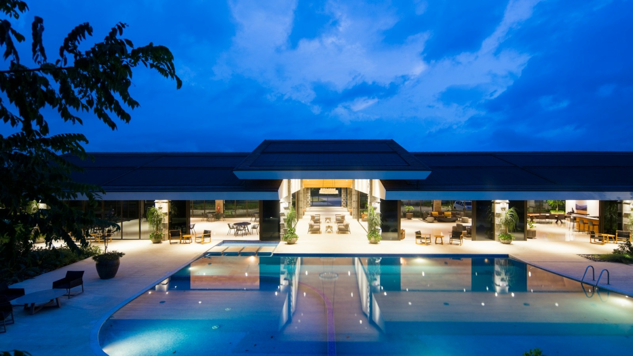 blue body of water in front of building near trees during nighttime