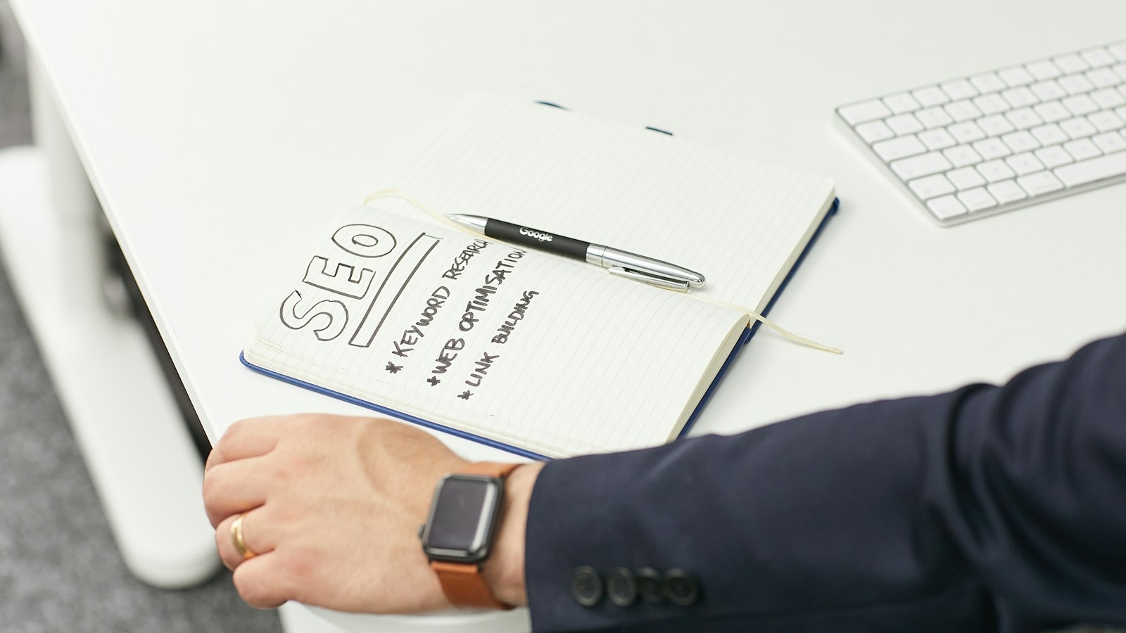 a person writing on a piece of paper