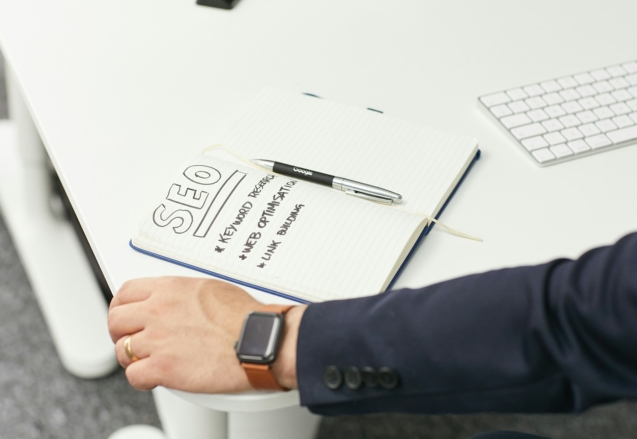 a person writing on a piece of paper