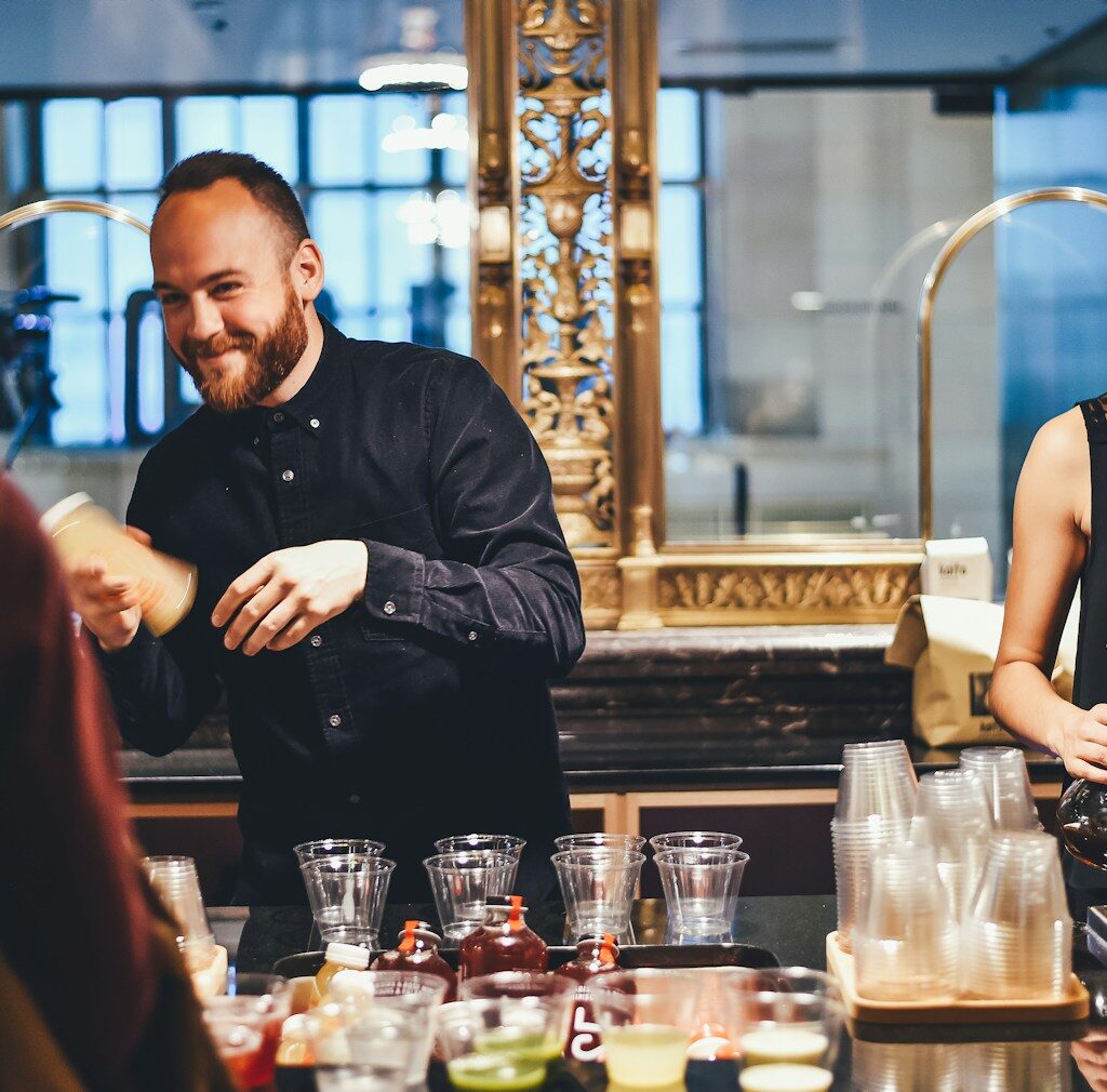 photo of man and woman mixing beverages