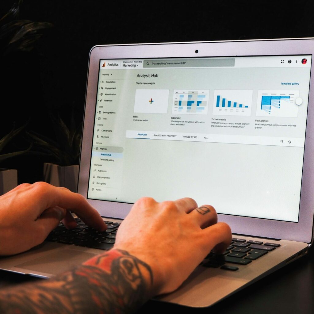 person using macbook pro on table