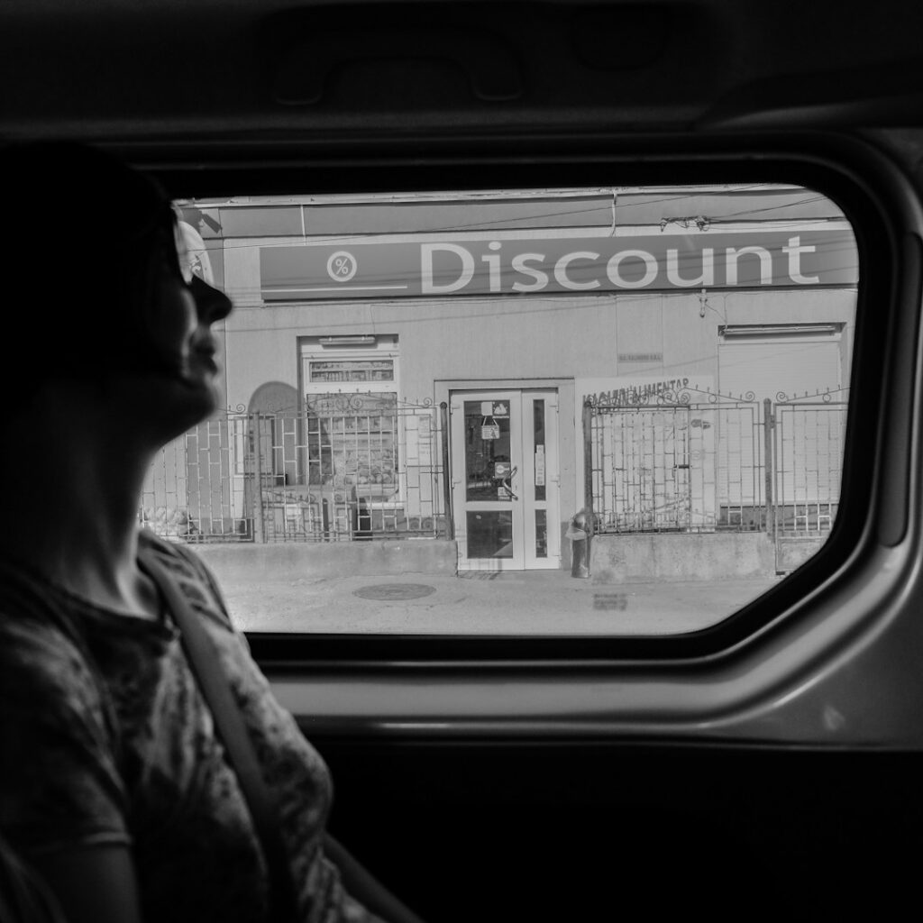 greyscale photography of woman inside vehicle