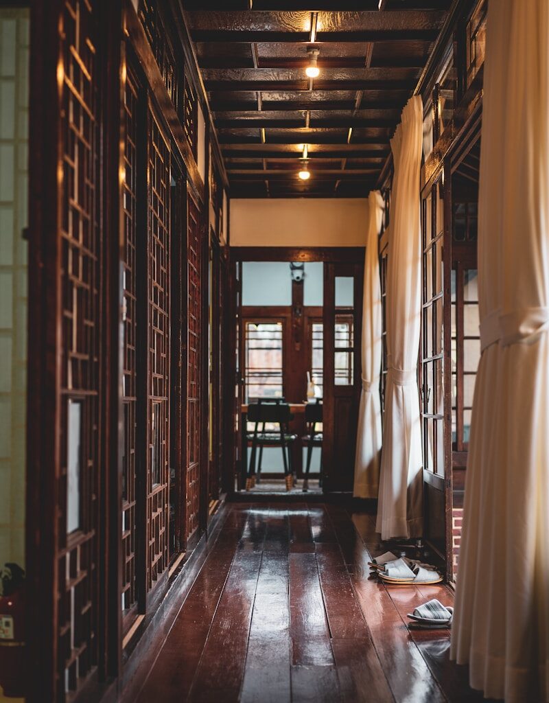 brown wooden room with white curtains