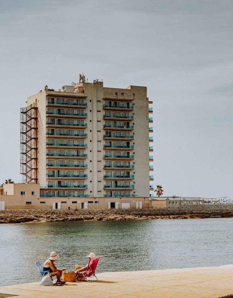 brown concrete building near body of water during daytime