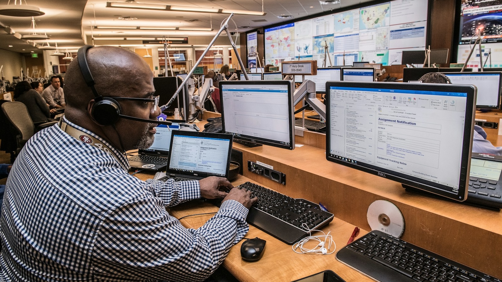 man in black and white checkered dress shirt using computer