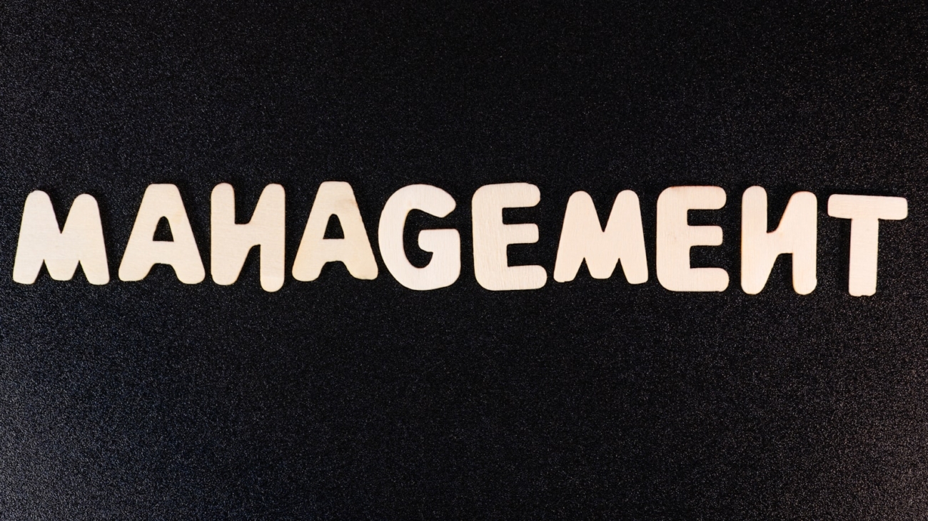 the word management written in white letters on a black background