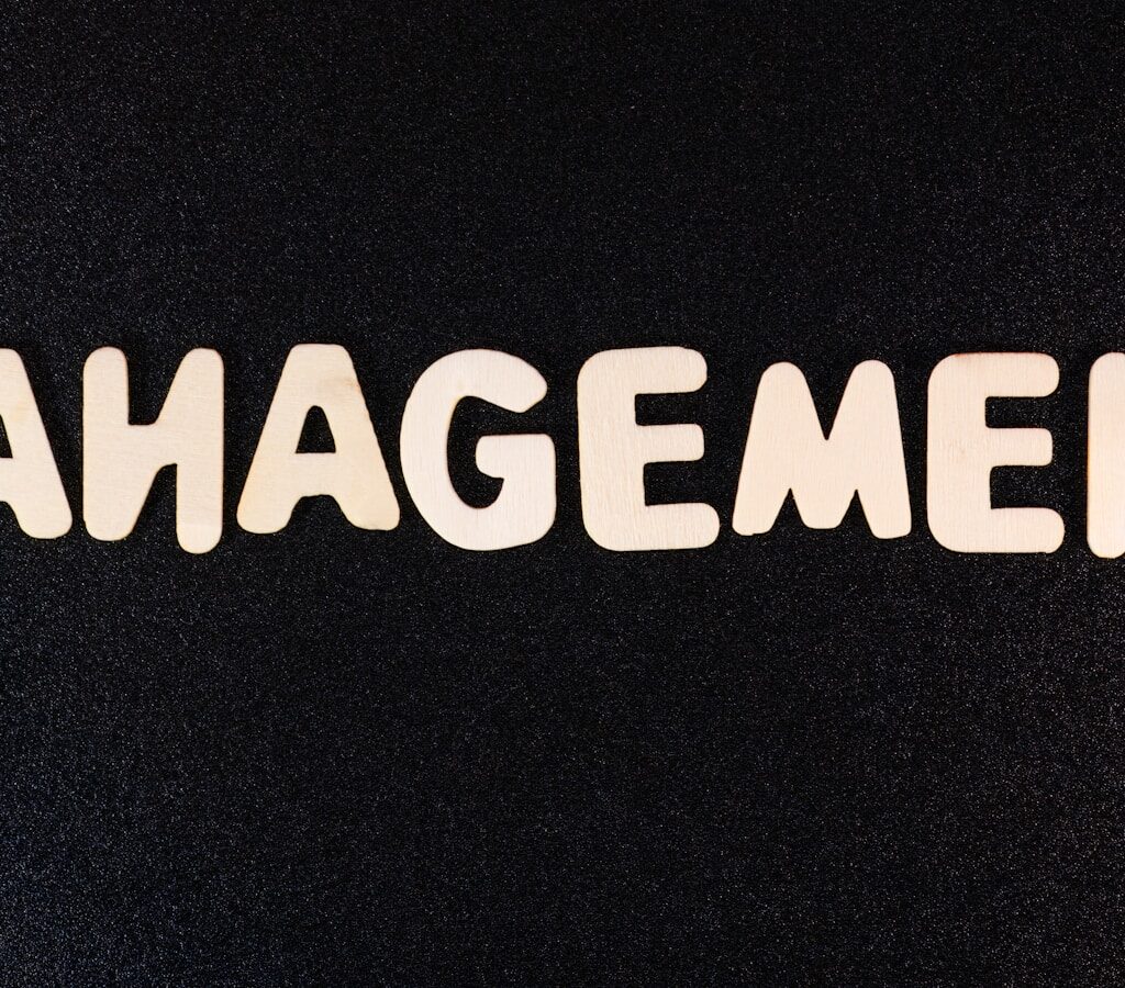 the word management written in white letters on a black background